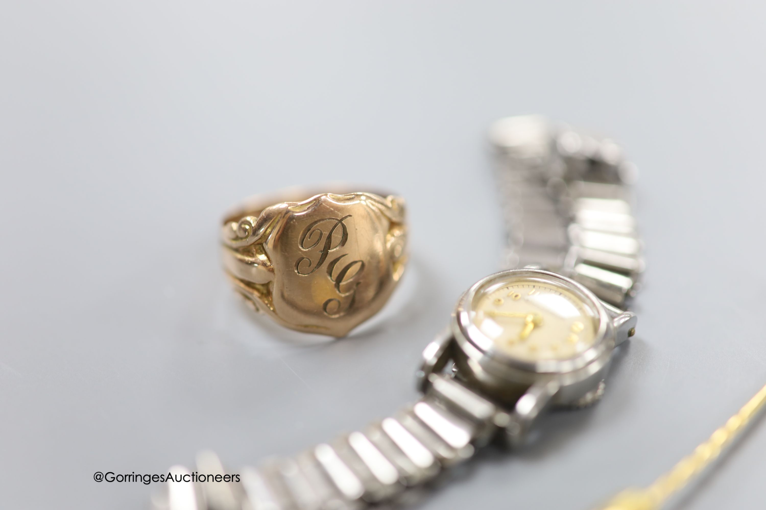A 9ct gold signet ring, size S, 4.1 grams, a yellow metal and diamond set stick pin and a lady's stainless steel Jaeger LeCoultre back wind wrist watch, on steel bracelet.